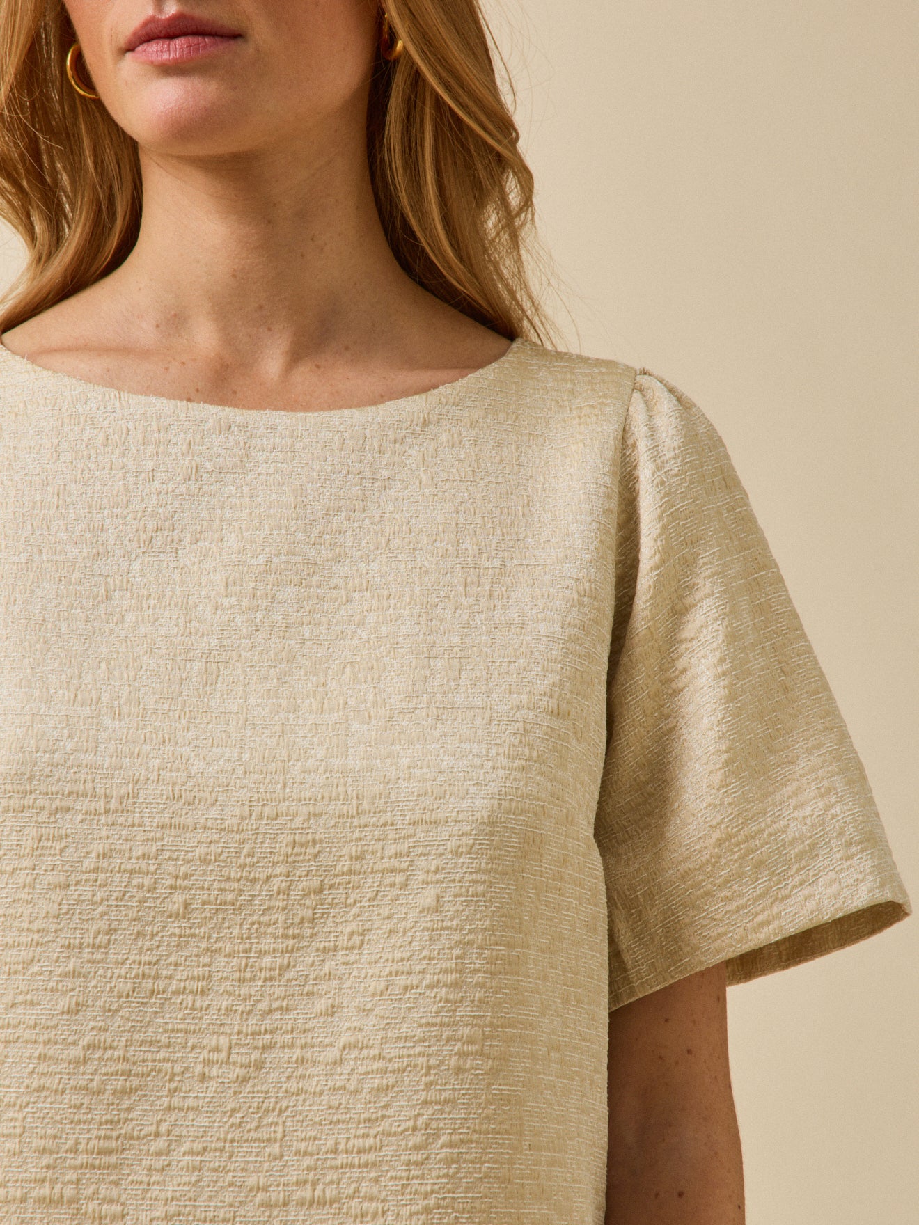 Korte feestelijke damesjurk in goudkleurig jacquard