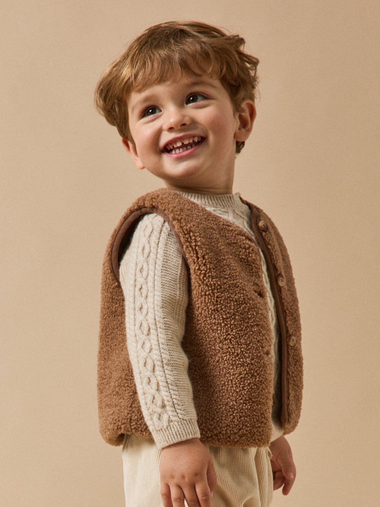 Mouwloos babyjasje in sherpa