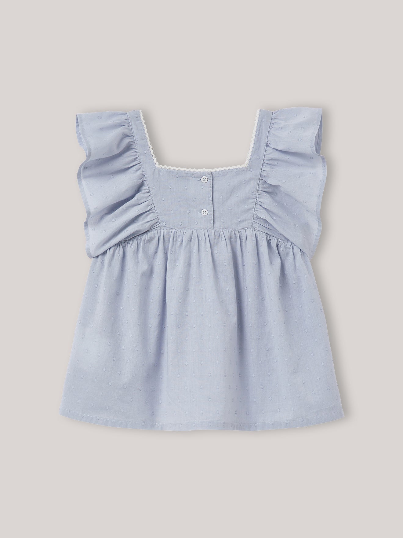 Meisjesbloesje in geborduurde plumetis